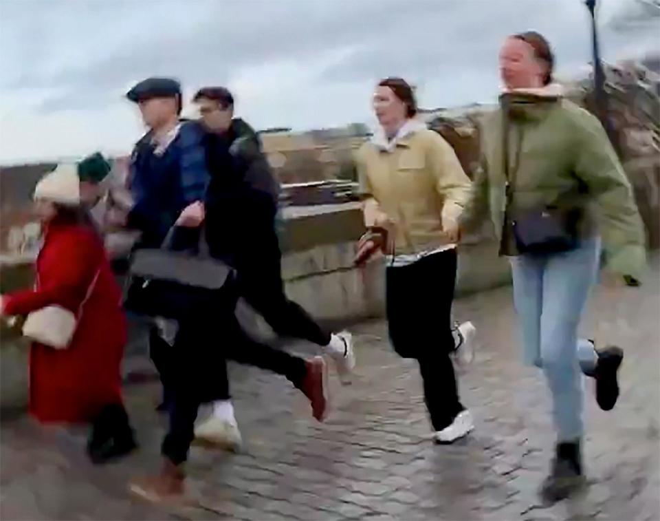 PHOTO: People run from the scene of a shooting in downtown Prague, Czech Republic, Dec. 21, 2023. (Leo Menindez)