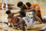 Oklahoma State guard Avery Anderson III, left, forward Matthew-Alexander Moncrieffe, right, and Baylor forward Jonathan Tchamwa Tchatchoua (23) fight for control of the ball in the first half of an NCAA college basketball game Saturday, Jan. 23, 2021, in Stillwater, Okla. (AP Photo/Sue Ogrocki)