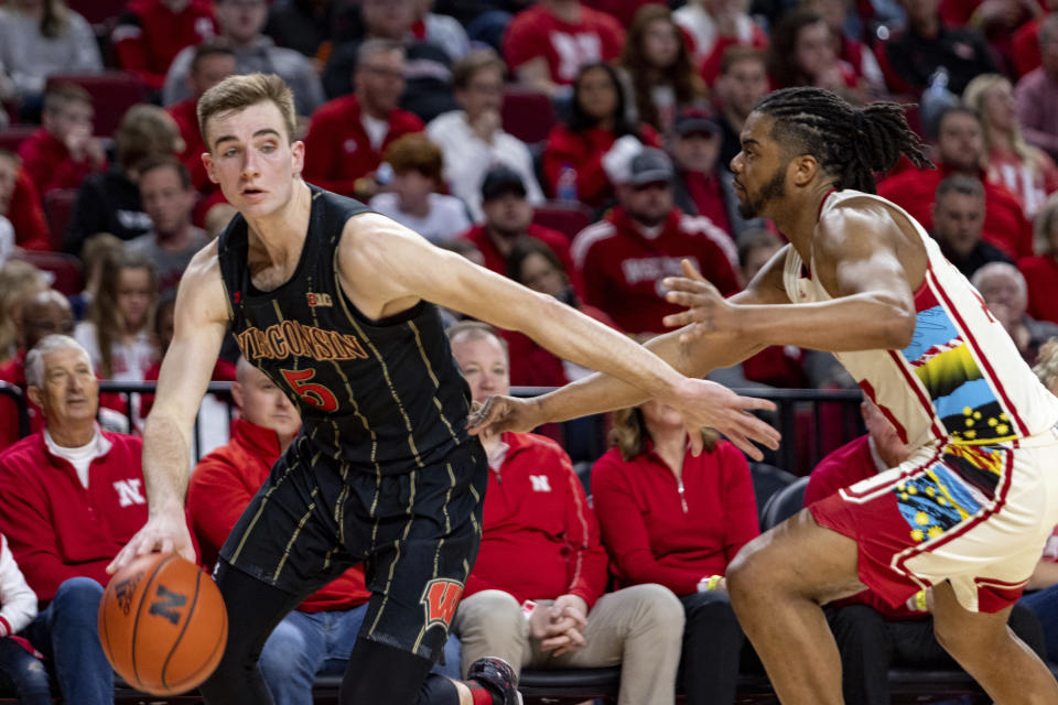 Wisconsin's Tyler Wahl (5) drives the baseline against Nebraska's Derrick Walker (13) in the second half during an NCAA college basketball game Saturday, Feb. 11, 2023, in Lincoln, Neb. (AP Photo/John Peterson)
