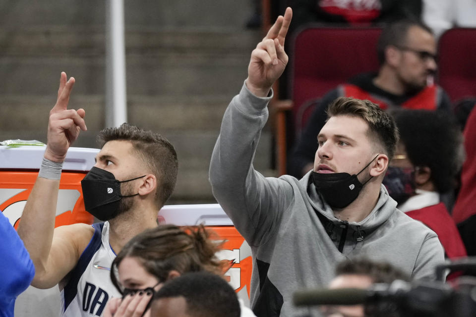 Dallas Mavericks guard Luka Doncic, right, reacts after a Maverick field goal during the second half of the team's NBA basketball game against the Houston Rockets, Friday, Jan. 7, 2022, in Houston. (AP Photo/Eric Christian Smith)
