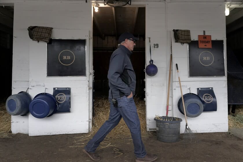 Trainer Tim Yakteen walks though his barn after taking Kentucky Derby entrants Tabia and Messier for workouts