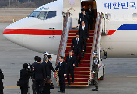 Chung Eui-yong, head of the presidential National Security Office, Suh Hoon, the chief of the South's National Intelligence Service, and other delegates arrive at a military airport in Seongnam, South Korea, March 6, 2018. REUTERS/Song Kyung-Seok/Pool