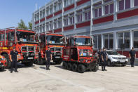 Romanian firefighters stand in front of fire engines during a ceremony, in Athens, on Saturday, July 2, 2022. Twenty eight Romanian firefighters, the first of more than 200 firefighters from other European countries that will help their Greek colleagues in fighting wildfires, were welcomed by Climate Crisis and Civil Protection Minister Christos Stylianides and the leadership of Greece's Fire Service. (AP Photo/Yorgos Karahalis)