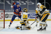 New York Islanders center Brock Nelson (29) reacts after Islanders center Jean-Gabriel Pageau (44) scored a goal against Pittsburgh Penguins goaltender Casey DeSmith (1) during the second period of an NHL hockey game, Sunday, Feb. 28, 2021, in Uniondale, N.Y. Pittsburgh Penguins defenseman Cody Ceci (4) is at right. (AP Photo/Kathy Willens)