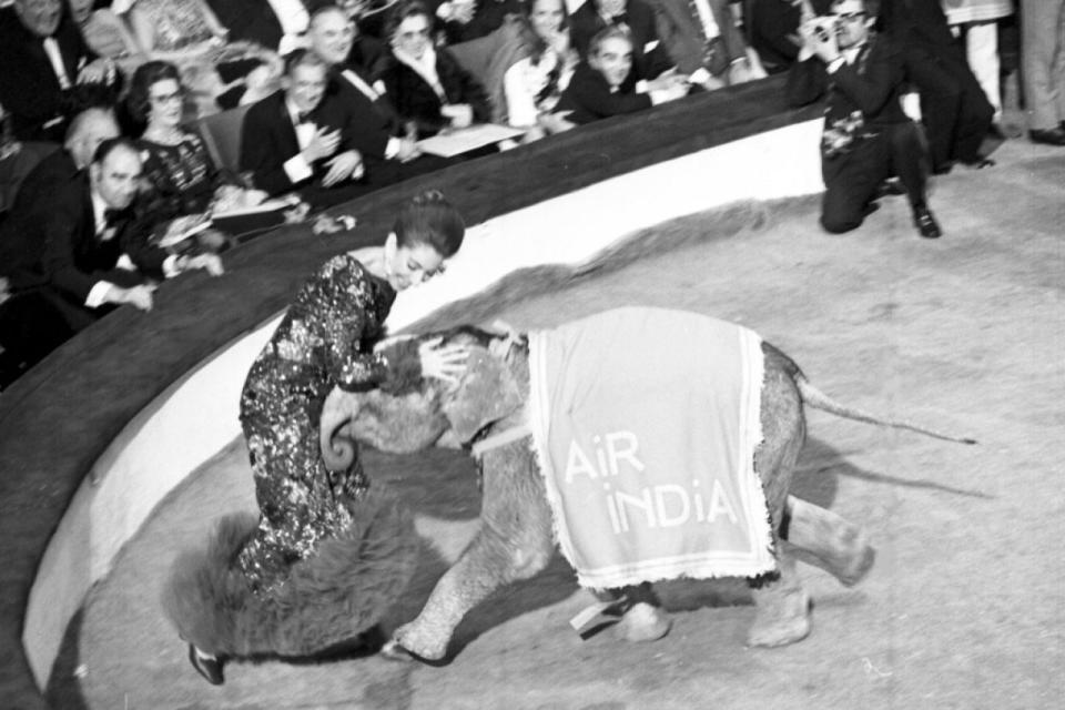 Callas is taken by surprise by baby elephant 'Djumbo', during the lottery draw at the 38th Gala of the Artists Union in Paris, France, April 23, 1971.