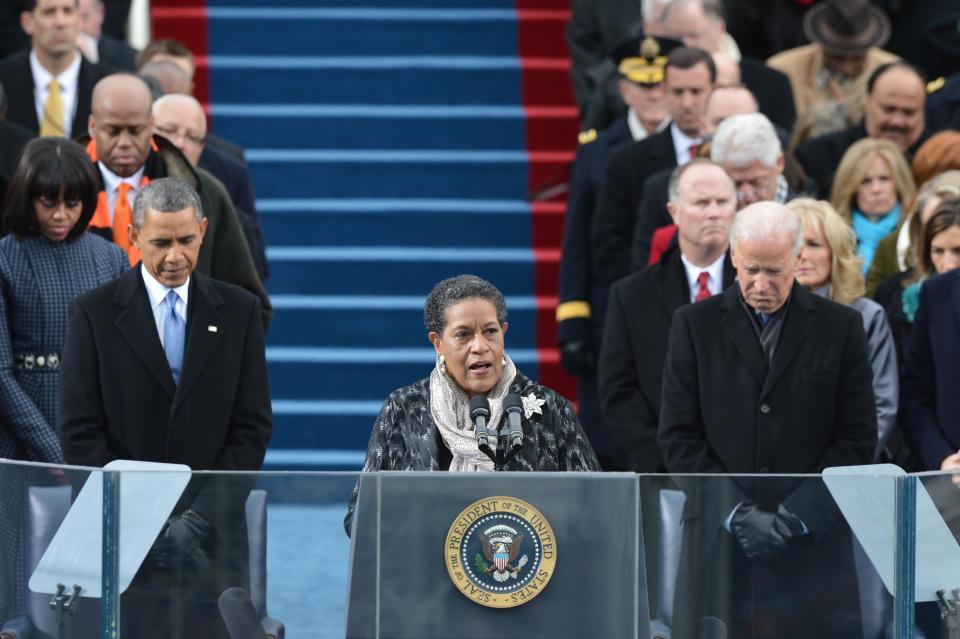 President Barack Obama and Vice President Joe Biden listen to an invocation by Myrlie Evers-Williams during the 57th Presidential Inauguration at the U.S. Capitol on Jan. 21, 2013, in Washington, D.C.  / Credit: JEWEL SAMAD/AFP via Getty Images