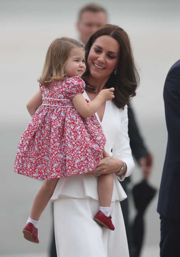 The Duchess of Cambridge wore Alexander McQueen while Charlotte wore a cute red dress. (Photo: PA)