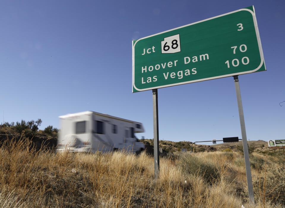 In this Friday, Nov. 8, 2013 photo, motorists head northbound on U.S. Highway 93, in Kingman, Ariz. Las Vegas and Phoenix are linked by U.S. 93, a road that narrows to two lanes and until recently backed up traffic over the Hoover Dam. Despite being two of the largest cities in the Southwest, they’re the only major metropolitan areas in the U.S. that aren’t directly connected by an interstate freeway. (AP Photo/Julie Jacobson)