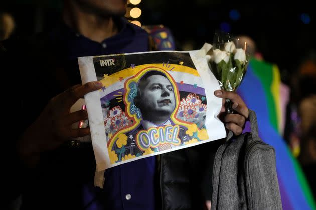 A demonstrator holds a picture of Jesús Ociel Baena in Mexico City on Nov. 13. The first openly nonbinary person to assume a judicial position in Mexico was found dead with their partner at home Monday in the central Mexican city of Aguascalientes.