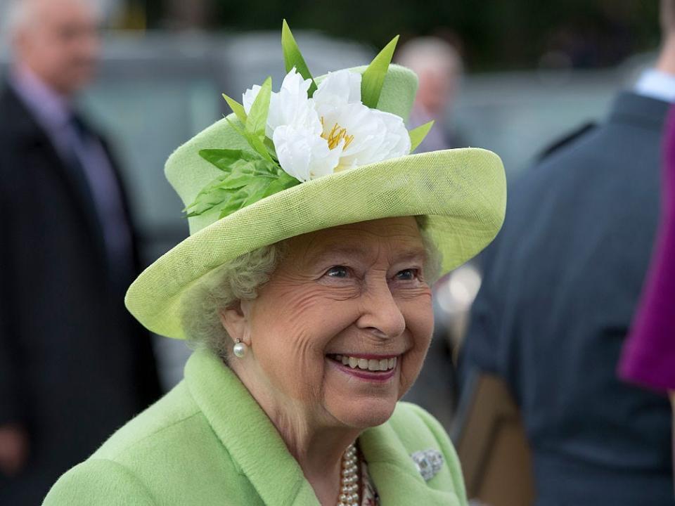 Queen Elizabeth in Ireland in 2016. She wears a lime green hat and coat.