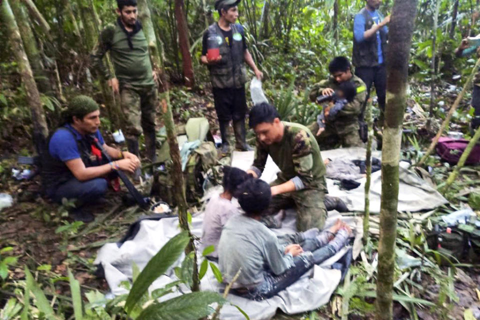 In this handout photo released on June 9, 2023, by the Colombian Presidency, members of the army assist four Indigenous children who were found alive after spending more than a month lost in the Colombian Amazon jungle following the crash of a small plane. Four Indigenous children were found alive Friday after spending more than a month lost in the Colombian Amazon rainforest following a small plane crash that triggered a massive rescue operation, the country's President Gustavo Petro said.  (Colombian Presidency via AFP - Getty Images)