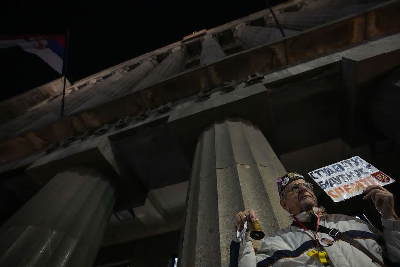 A man holds a banner that reads: "Students Future of Serbia" during protest in front of Serbia's Constitutional Court building in Belgrade, Serbia, Friday, Jan. 26, 2024.