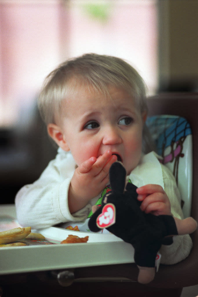 a kid sucks on a teenie beanie