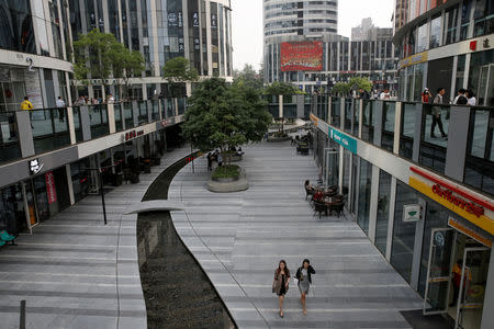 Women walk in the Sanlitun shopping district in Beijing, China May 15, 2019. REUTERS/Thomas Peter