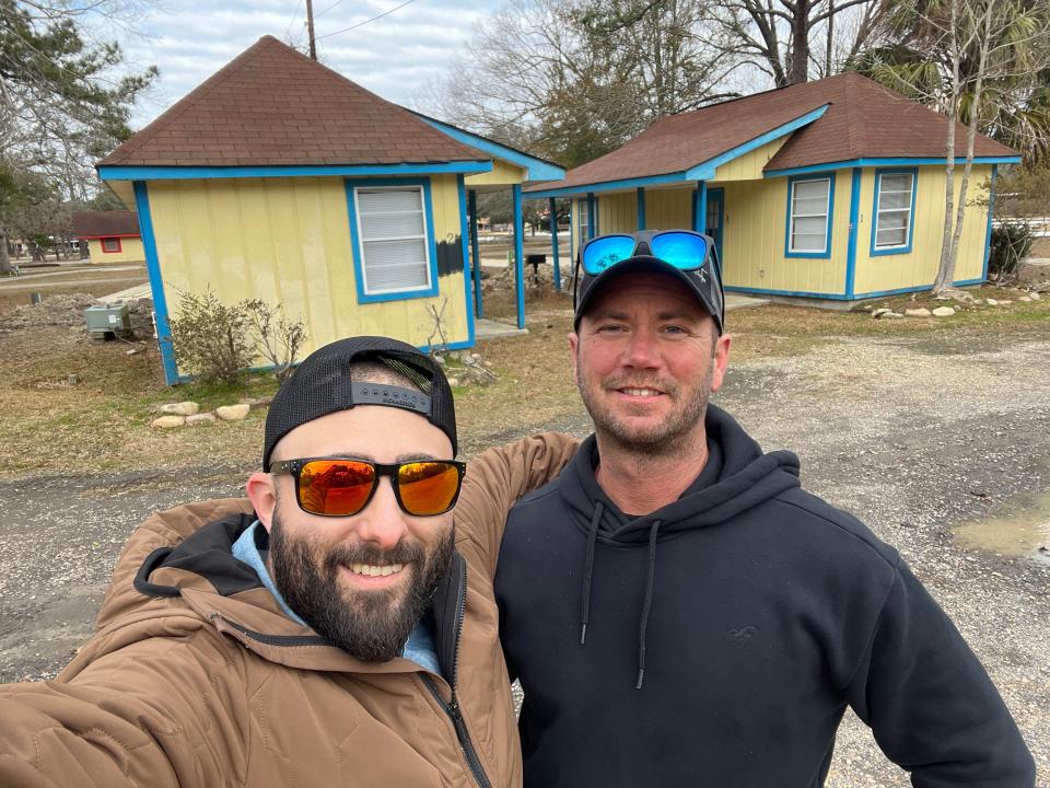 Mike Re and Chris Galvin, Aberdeen handymen, pose in front of a pair of cabins that will be renovated for the upcoming reality show "Cabin Wars: Flip It To Win It."