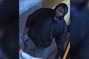 Surveillance photo entered into evidence that shows the person who robbed a Philadelphia Dunkin Donuts and killed the person working there. Philadelphia authorities have said they will arrest Keith Gibson for that crime once his criminal court proceedings conclude in Delaware.