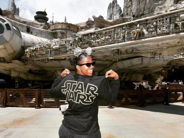 Amber wearing a star wars shirt standing at the edge of the galaxy in disneyland