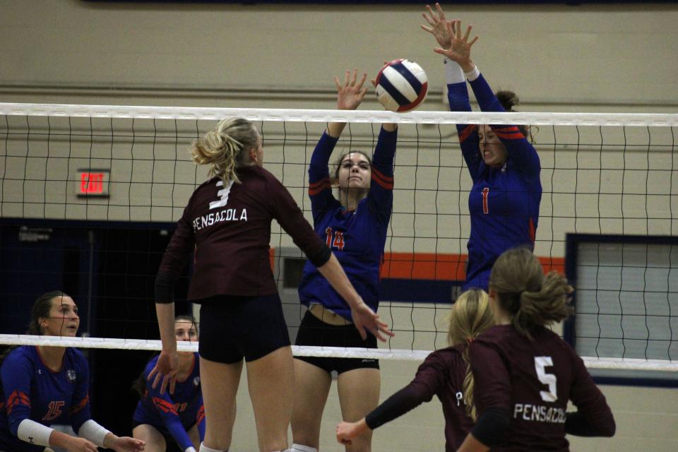 Bolles' Sophia Albaugh (14) and Grace Albaugh (1) combine to block a hitting attempt by Pensacola's Harper Wiggins (3) during an FHSAA Region 1-4A high school volleyball quarterfinal on October 25, 2022. [Clayton Freeman/Florida Times-Union]