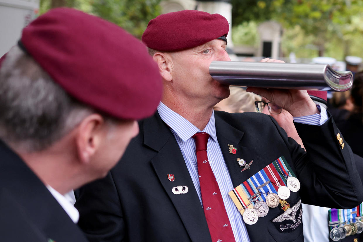 A veteran drinks from a flask on The Mall on the day of the state funeral and burial of Britain’s Queen Elizabeth in London, Britain September 19, 2022.   REUTERS/Kevin Coombs