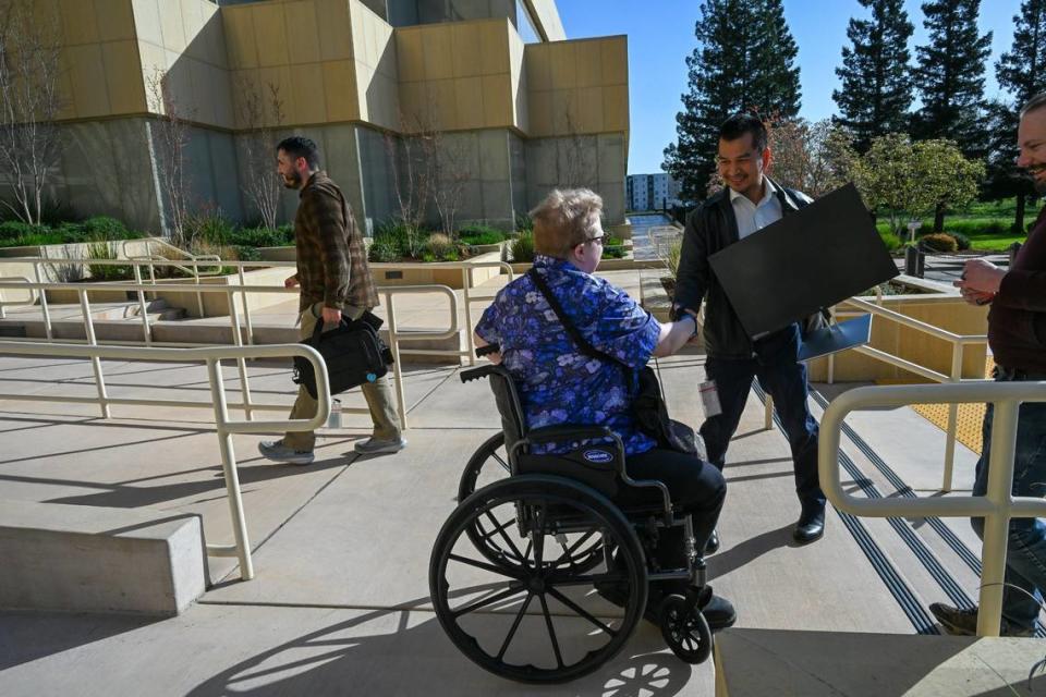 Evan Underwood, center, returns his Department of General Services computer equipment on March 8 after he quit his job because he could no longer work remotely full-time.