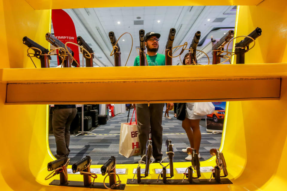 Visitors view displayed firearms during the Tactical, Survival and Arms Expo in Pasay City, the Philippines, Nov.15, 2019.<span class="copyright">Rouelle Umali/Xinhua via Getty</span>