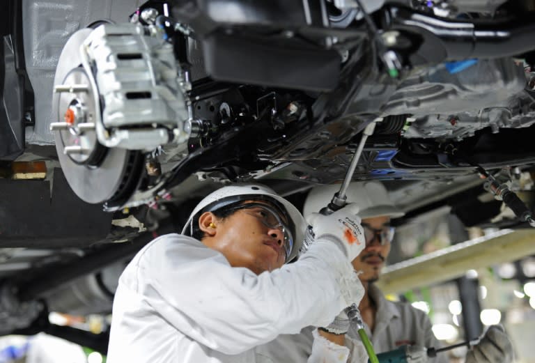 Employees working on a car assembly line at a Honda plant in Ayuthaya, north of Bangkok