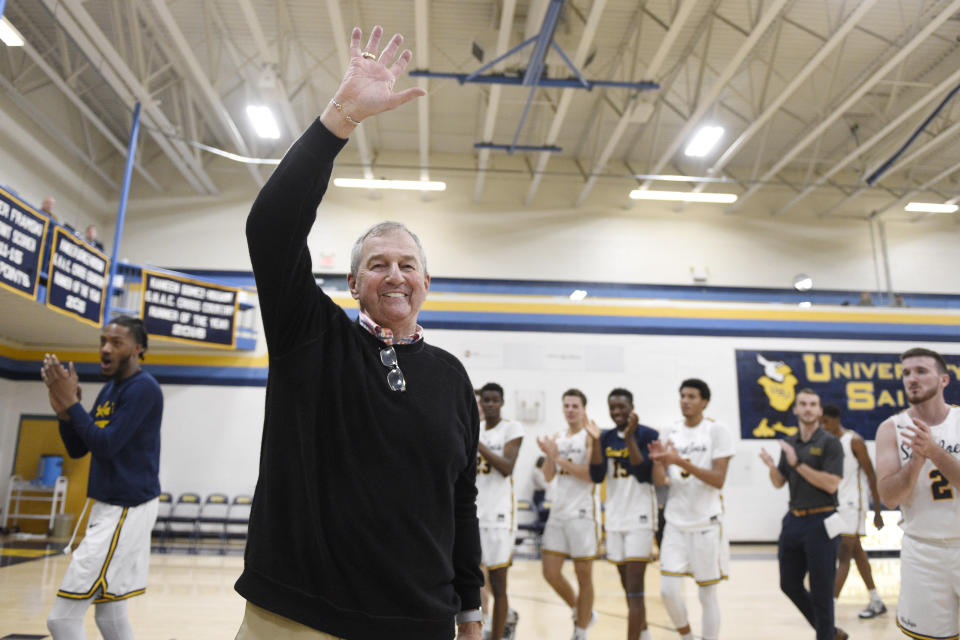 FILE - Saint Joseph coach Jim Calhoun smiles and waves to fans after the team's win in an NCAA college basketball game Jan. 10, 2020, in West Hartford, Conn. Calhoun, who led UConn to three national titles, has retired again, this time from Division III Saint Joseph. (AP Photo/Jessica Hill, File)