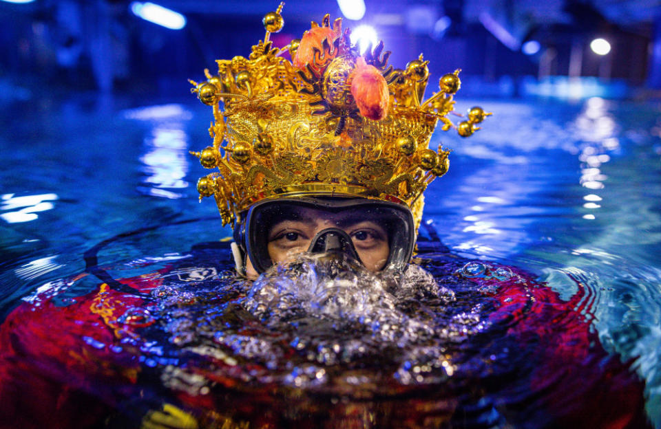 People swim in aquarium tank to celebrate Lunar New Year