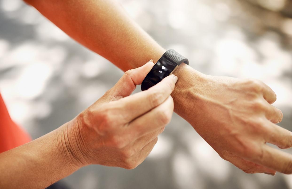 woman checking heart rate on fitness watch