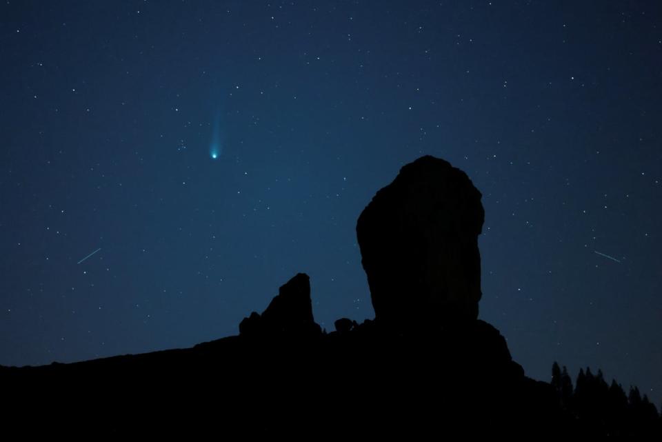 Comet 12P/Pons-Brooks is photographed over the Roque Nublo Natural Monument in Tejeda, on Gran Canaria Island (Reuters)