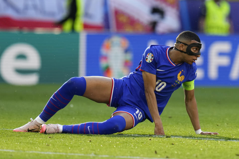 Kylian Mbappe of France goes down on the pitch during a Group D match between France and Poland at the Euro 2024 soccer tournament in Dortmund, Germany, Tuesday, June 25, 2024. (AP Photo/Hassan Ammar)