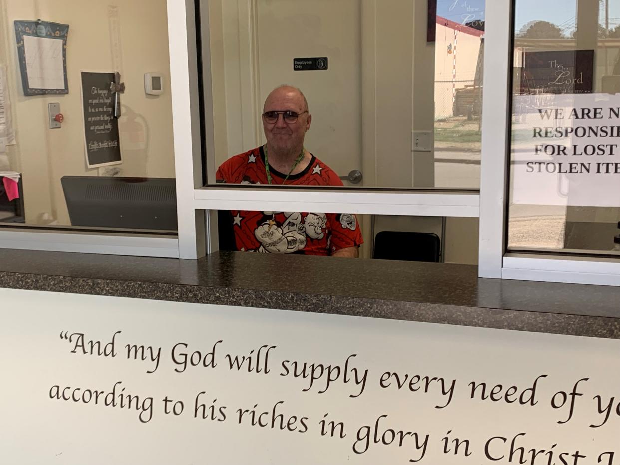 John Bargelski, who used to benefit from services at Love and Care Ministries, is now employed there. On March 13, 2024, he sits ready to welcome clients to come in, have a shower and a new outfit, thanks to Love and Care Ministries.