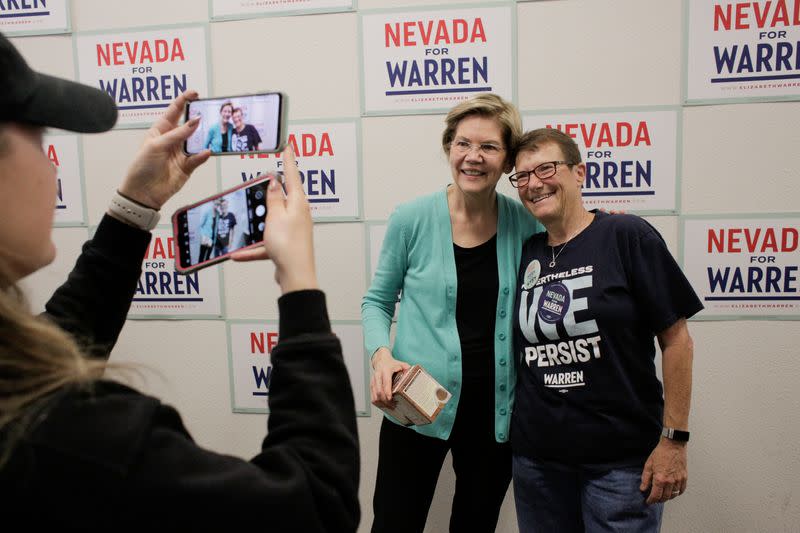 U.S. Democratic presidential candidate Senator Elizabeth Warren takes a photo with a supporter as she holds a "Canvass Kickoff" event at her campaign field office in North Las Vegas