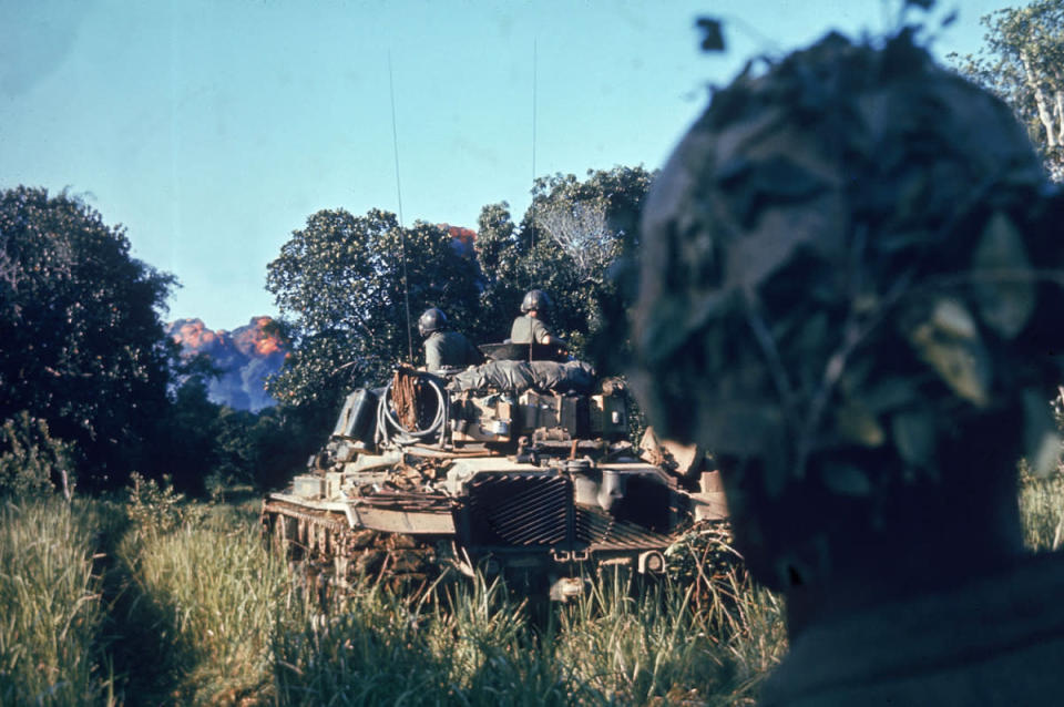 Caption from LIFE. "Escorted by tanks and supported by air strikes that sear the jungle just ahead, troops of the Second Battalion, Fifth Marines, begin a sweep." Vietnam, October 1966. (Larry Burrows—Time & Life Pictures/Getty Images) <br> <br> <a href="http://life.time.com/history/life-behind-the-picture-larry-burrows-reaching-out-1966/#1" rel="nofollow noopener" target="_blank" data-ylk="slk:Click here to see the full collection at LIFE.com;elm:context_link;itc:0;sec:content-canvas" class="link ">Click here to see the full collection at LIFE.com</a>