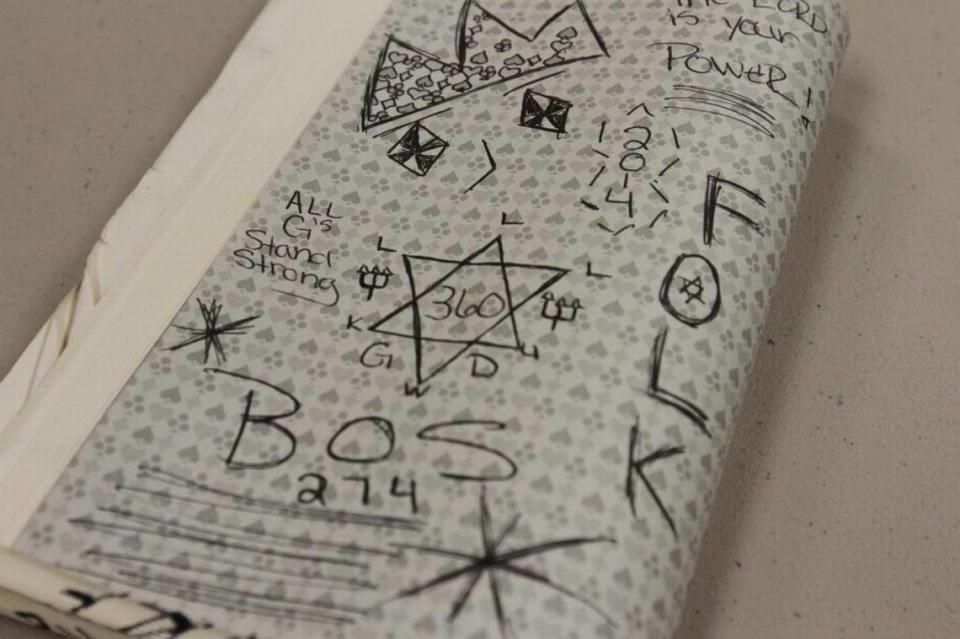 Gang-related graffiti in a book confiscated at the George/Green County Regional Correctional Facility in Lucedale, where officials say a significant portion of the inmates are gang members.