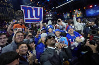 LSU wide receiver Malik Nabers celebrates with fans after being chosen by the New York Giants with the sixth overall pick during the first round of the NFL football draft, Thursday, April 25, 2024, in Detroit. (AP Photo/Paul Sancya)