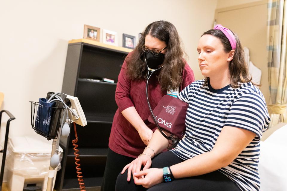 Internist Rebecca Mishuris measures 30-year-old Rachel Albrecht's vital signs during a recent visit.