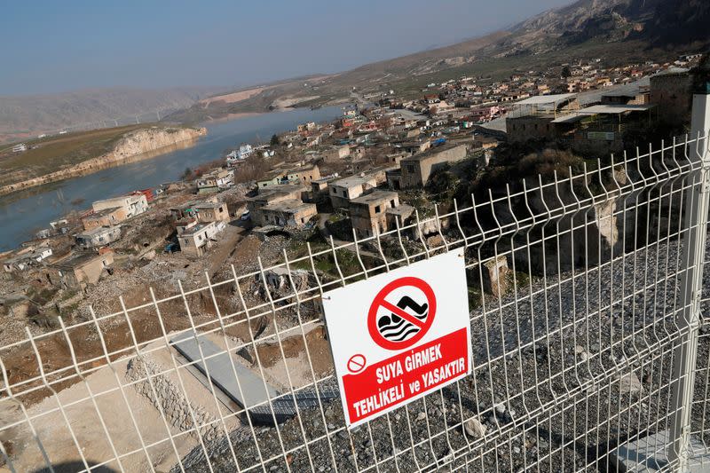 A sign is seen near the level where water is expected to reach above the demolished part of Hasankeyf village