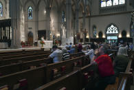 Parishioners kneel as the Very Rev. Kris Stubna leads Mass at St. Paul Catholic Cathedral in Pittsburgh on Sunday, June 26, 2022. (AP Photo/Jessie Wardarski)