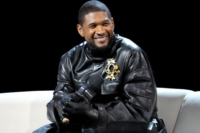 <p>Jeff Kravitz/FilmMagic</p> Usher speaks onstage during the Super Bowl LVIII Pregame & Apple Music Super Bowl LVIII Halftime Show Press Conference at the Mandalay Bay Convention Center in February 2024 in Las Vegas