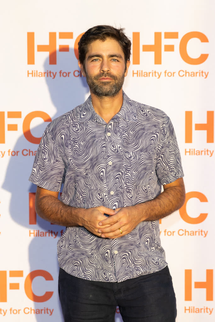 Adrian in a patterned shirt posing at Hilarity for Charity event