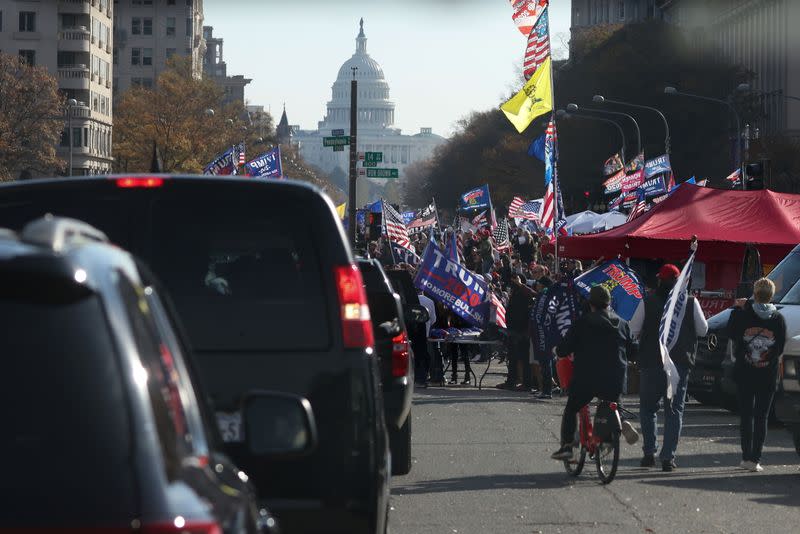 Supporters of President Trump cheer alongside the presidential motorcade at Freedom Plaza near the White House in Washington