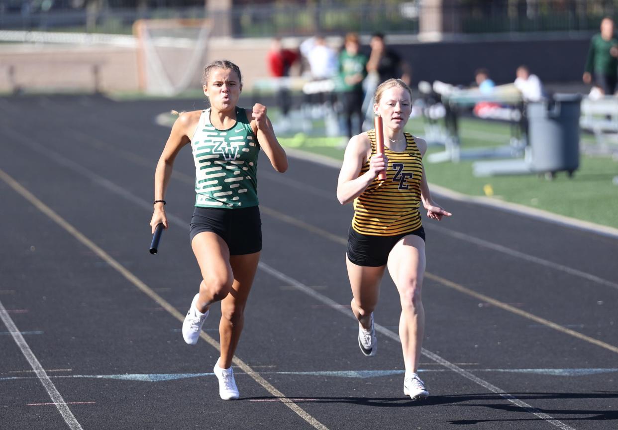 Zeeland East's Cece Huizingh, right aims for the finish line against Zeeland West.