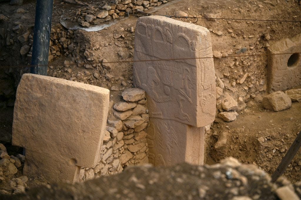 A pillar with animals carved on it