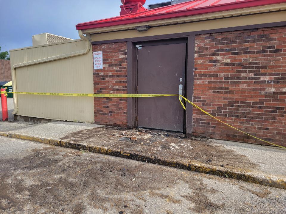 Caution tape is lined along the Pizza Hut building on River Avenue after an attic fire left the business closed.
