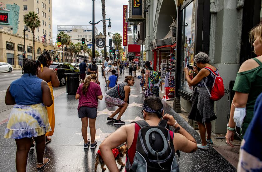 LOS ANGELES, CA - AUGUST 11, 2021: Despite the Delta variant, tourists are still flocking to Hollywood Boulevard to check out the Walk of Fame and other iconic sites on August 11, 2021 in Los Angeles, California.(Gina Ferazzi / Los Angeles Times)