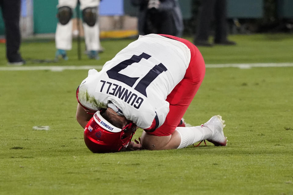 Arizona quarterback Grant Gunnell (17) rolls on the ground after going down with an injury on the first play from scrimmage during the first half of an NCAA college football game against UCLA on Saturday, Nov. 28, 2020, in Pasadena, Calif. (AP Photo/Marcio Jose Sanchez)