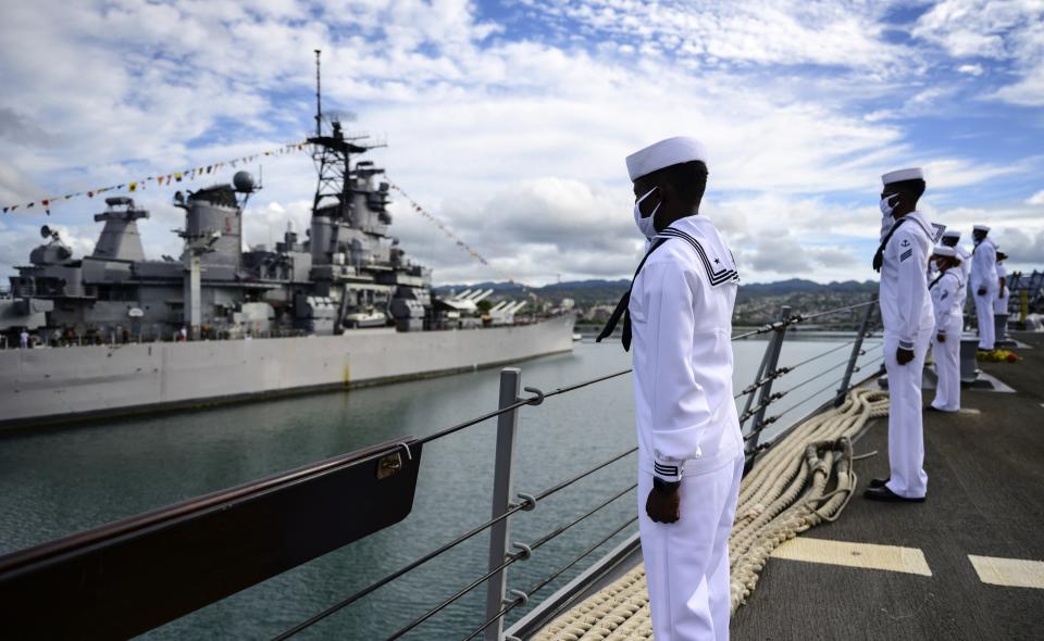 In this image provided by the U.S. Navy, sailors aboard the guided-missile destroyer USS Michael Murphy (DDG 112) render honors to Battleship Missouri Memorial during the official ceremony for the 75th anniversary of the Japanese surrender that ended World War II, Wednesday, Sept. 2, 2020, in Honolulu, Hawaii. (Petty Officer 1st Class Devin Langer/U.S. Navy via AP)