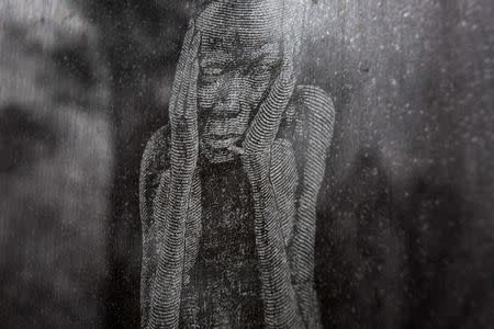 An etching on a memorial wall depicts a suffering slave at the Whitney Plantation in Wallace, Louisiana January 13, 2015. REUTERS/Edmund Fountain