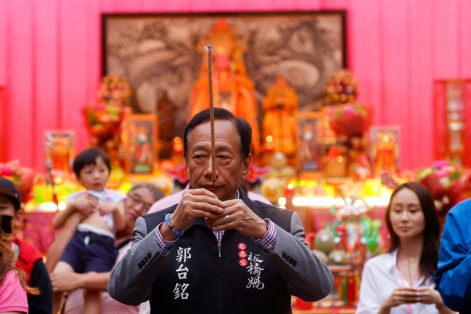 Terry Gou, the founder of major Apple supplier Foxconn and a contender to be Taiwan's next president, prays before a campaign rally event